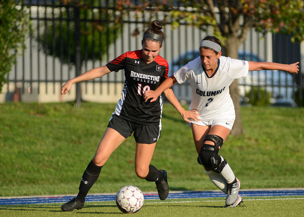 Sydney Routh and Elisa Vega fight for possession